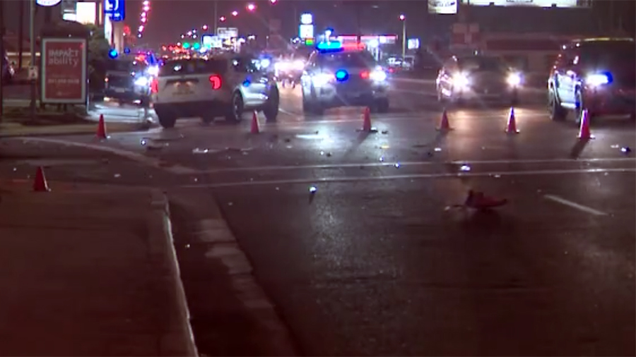 scene of a crash with police cars and debris in the road...