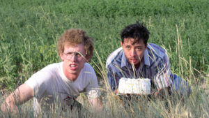 Two men on the ground in weeds
