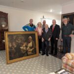 Special Agent Gary France (second right), Dr. Francis Wood and Wood’s children stand next to the John Opie painting that was stolen from Wood’s parents' home in 1969. (FBI)