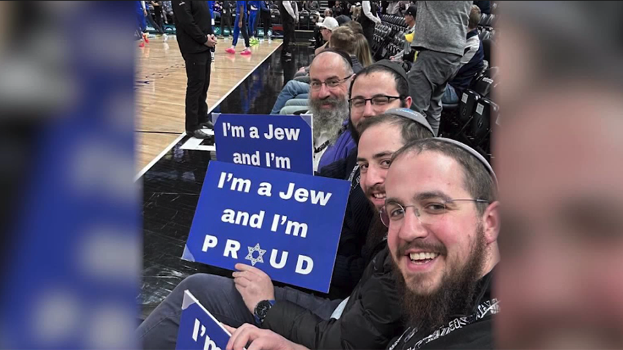 Rabbi Avremi Zippel and three others held signs at the Utah Jazz game hosting the Dallas Mavericks ...