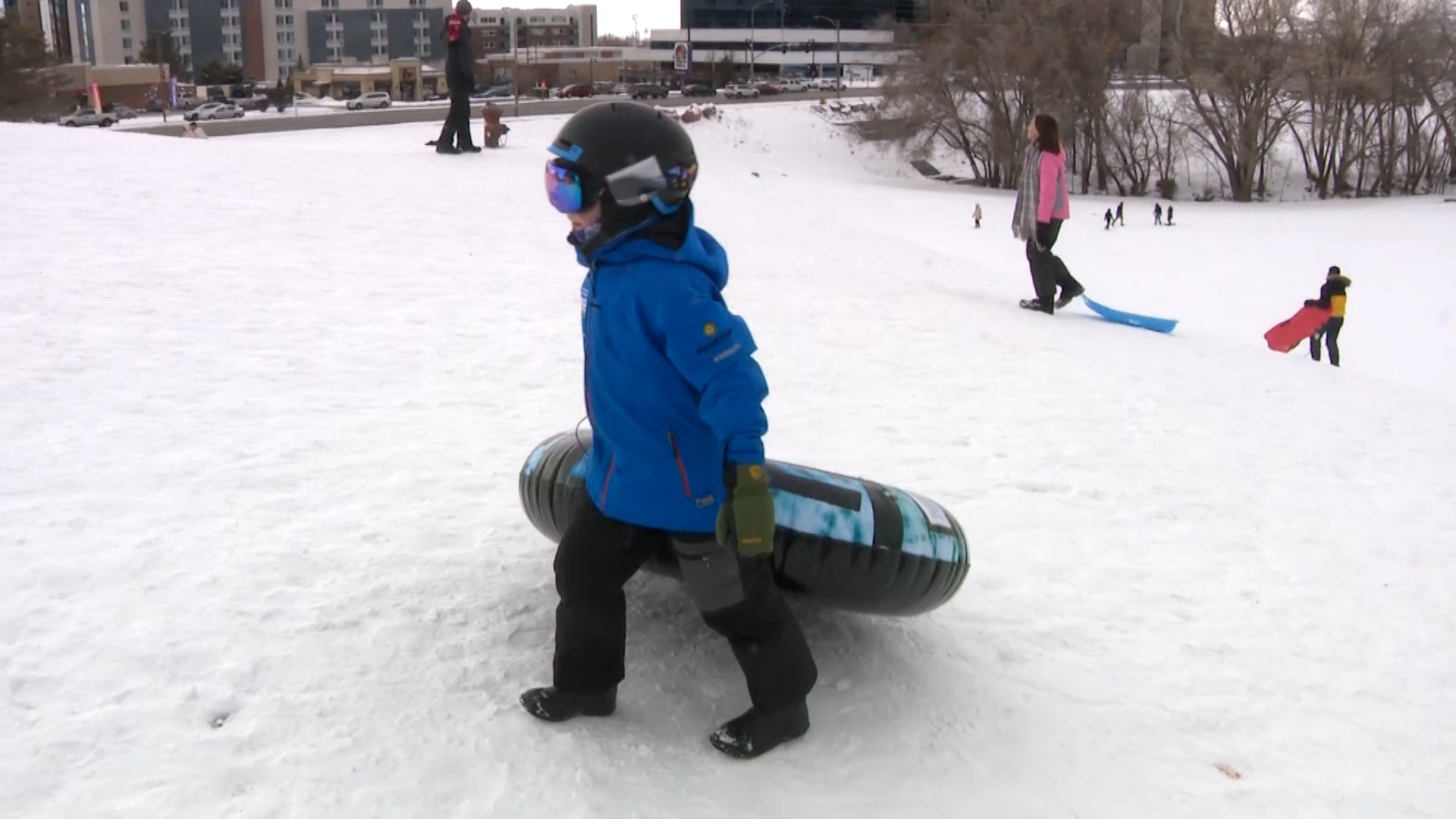 A kid at Sugar House park sledding with his helmet....