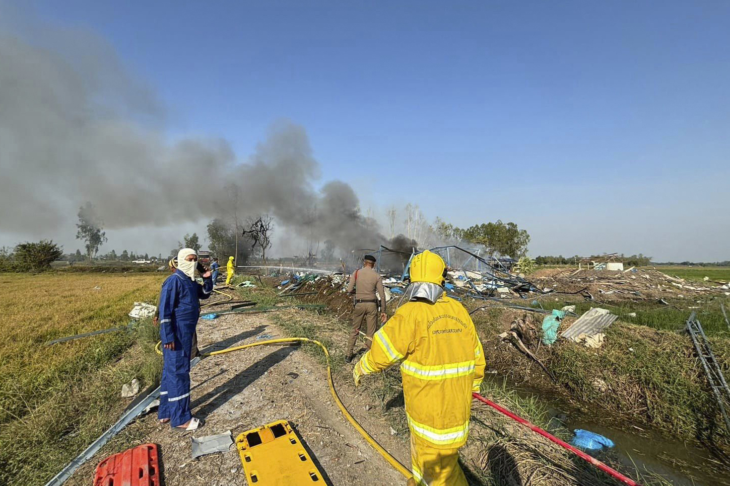 Firefighters work on a cite of an explosion at a firework factory in Suphan Buri province, Thailand...