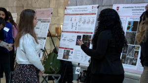 Undergraduates inside of the state rotunda present their research.