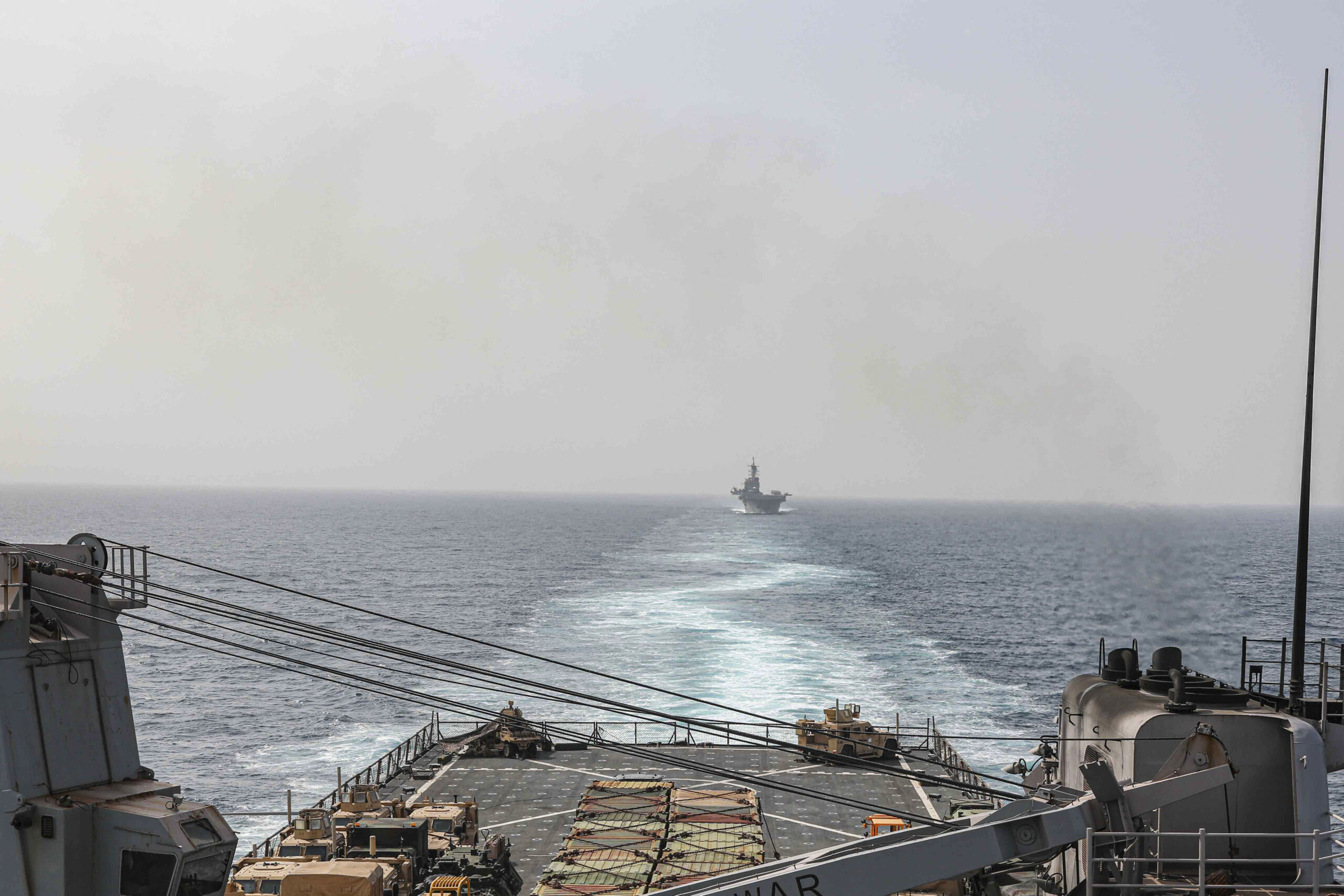 In this image provided by the U.S. Navy, the amphibious dock landing ship USS Carter Hall and amphi...