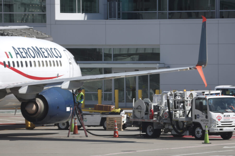 FILE - A worker refuels an AeroMexico plane at San Francisco International Airport on March 07, 202...