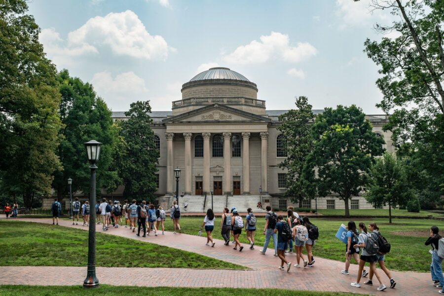 People walk on the campus of the University of North Carolina Chapel Hill in June 2023, in Chapel H...