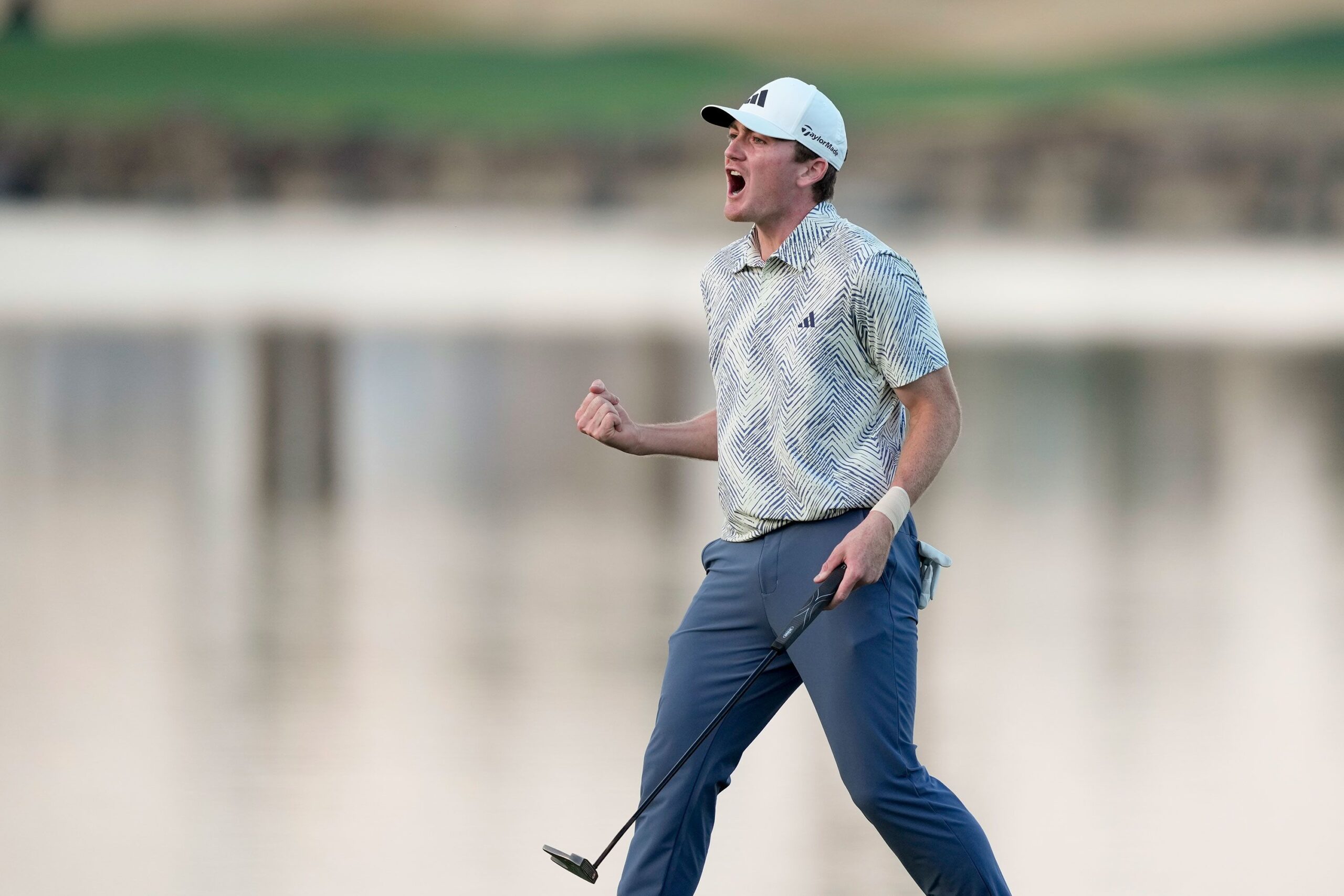 Nick Dunlap reacts after making his putt on the 18th hole of the Pete Dye Stadium Course during the...
