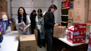 Women prepare donations in a garage