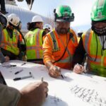 Construction team members gather Tuesday, February 13, 2024, to sign some of the final reinforcing steel that will go atop the Salt Lake Temple.
 2024 by Intellectual Reserve, Inc. All rights reserved.
