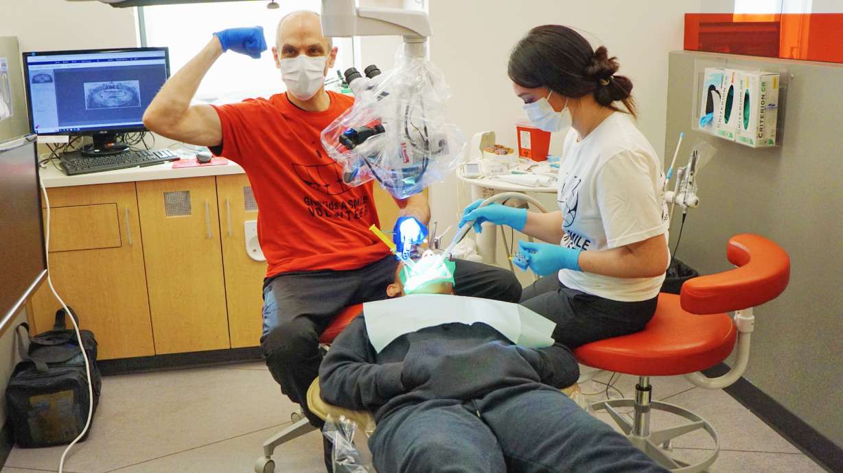 A volunteer dentist and a University of Utah dental student perform an examination during the "Give...
