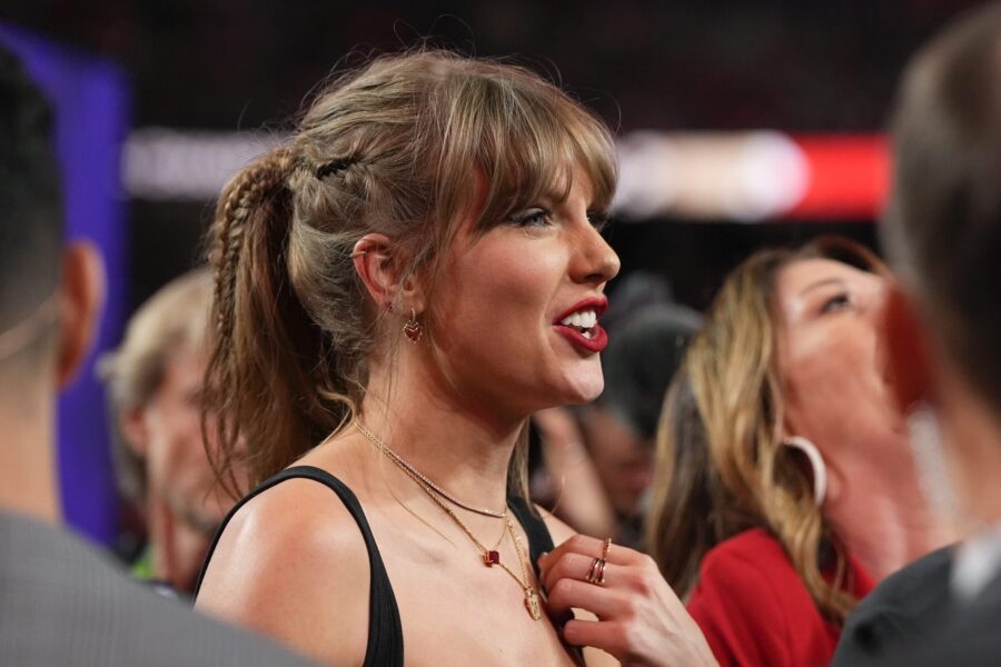 Taylor Swift watches the celebration on the field after the NFL Super Bowl 58 football game between...