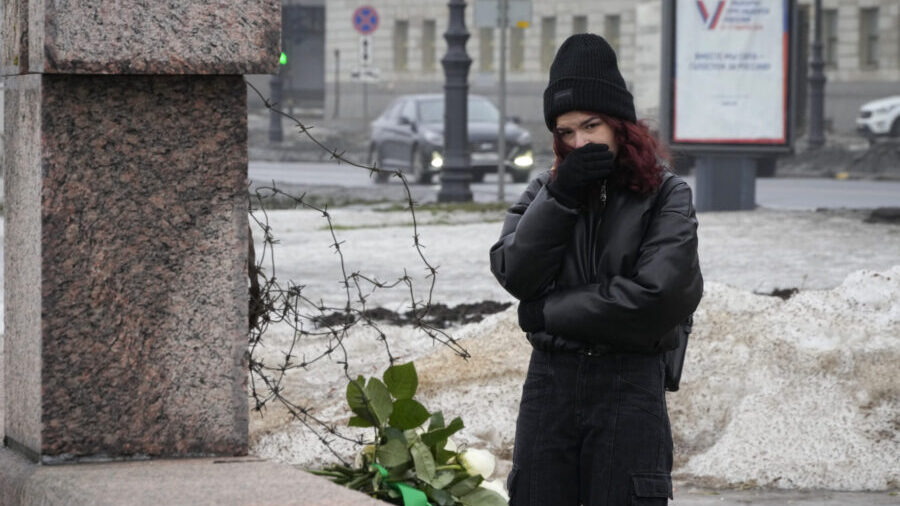 A woman reacts as she came to lay flowers paying the last respect to Alexei Navalny at the Memorial...
