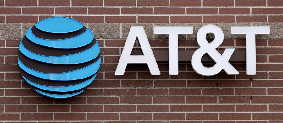 FILE - The company logo hangs over the door to an AT&T store Thursday, Feb. 22, 2024, in Denver...