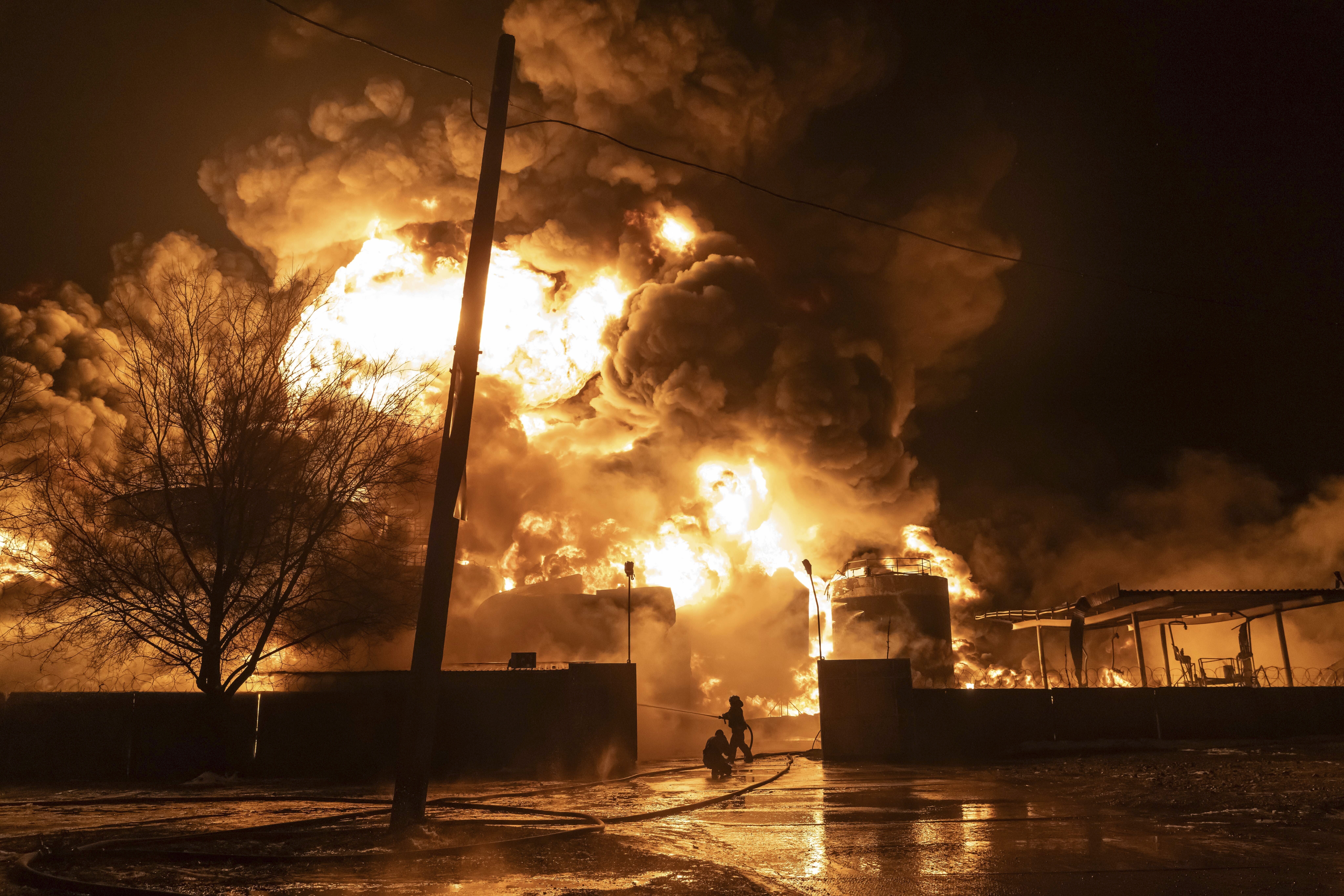 FILE - Firefighters extinguish a fire after a Russian attack on a residential neighborhood in Khark...