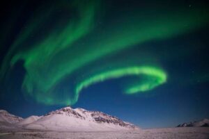 green lights in swirl shapes above a snow plane