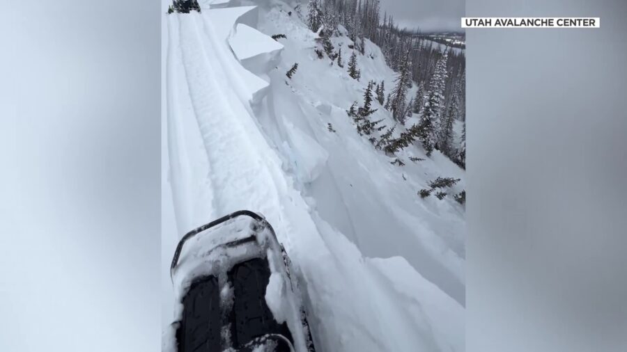 U.S. Forest Service Utah Avalanche Center forecasters nearly avoiding sliding off the edge of a mou...