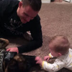 Cody Barton with a K-9 officer and an infant. (Courtesy: Sarah Barton)