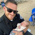 Cody Barton holds an infant. (Courtesy: Sarah Barton)