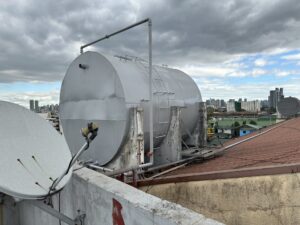 One of the new water tanks atop an apartment building. 
