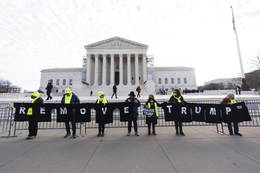 Protesters hold their banners in front of the U.S. Supreme Court, Thursday, Feb. 8, 2024, in Washin...