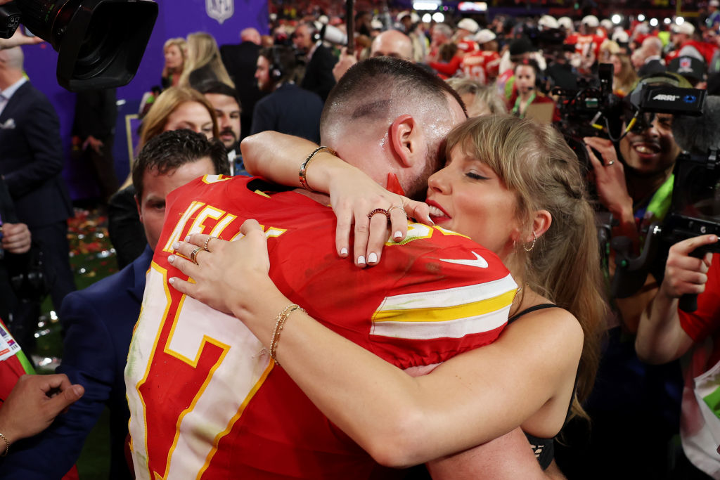 Travis Kelce #87 of the Kansas City Chiefs and Taylor Swift embrace after defeating the San Francis...