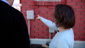 Neilson-Berg pointing to the Google Fiber router outside her home.