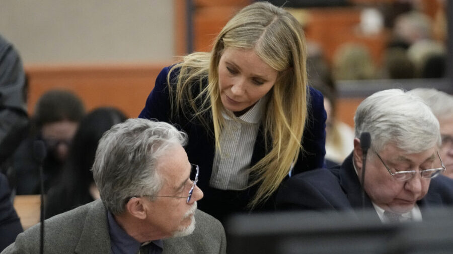 Gwyneth Paltrow speaks with retired optometrist Terry Sanderson, left, as she walks out of the cour...