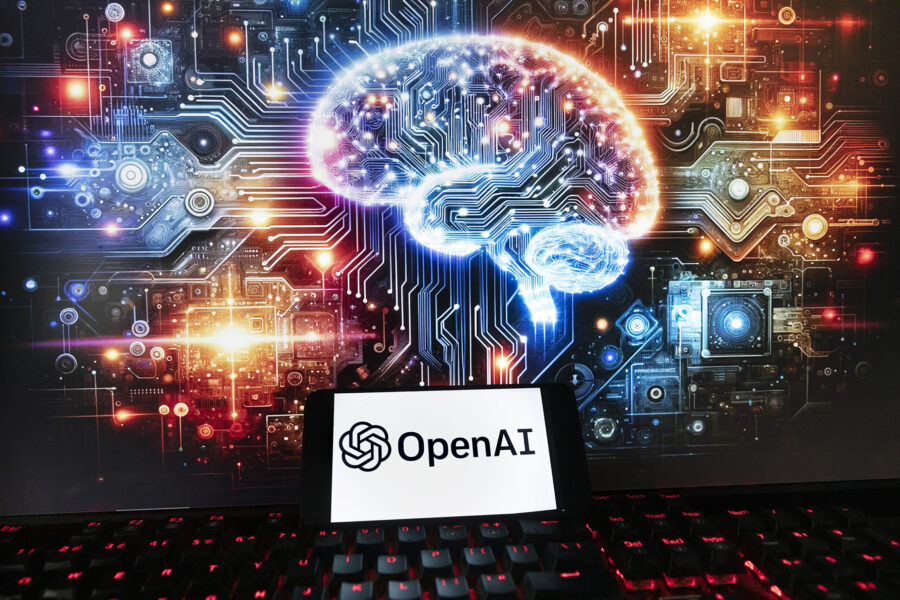 FILE - The OpenAI logo is displayed on a cell phone with an image on a computer monitor generated b...