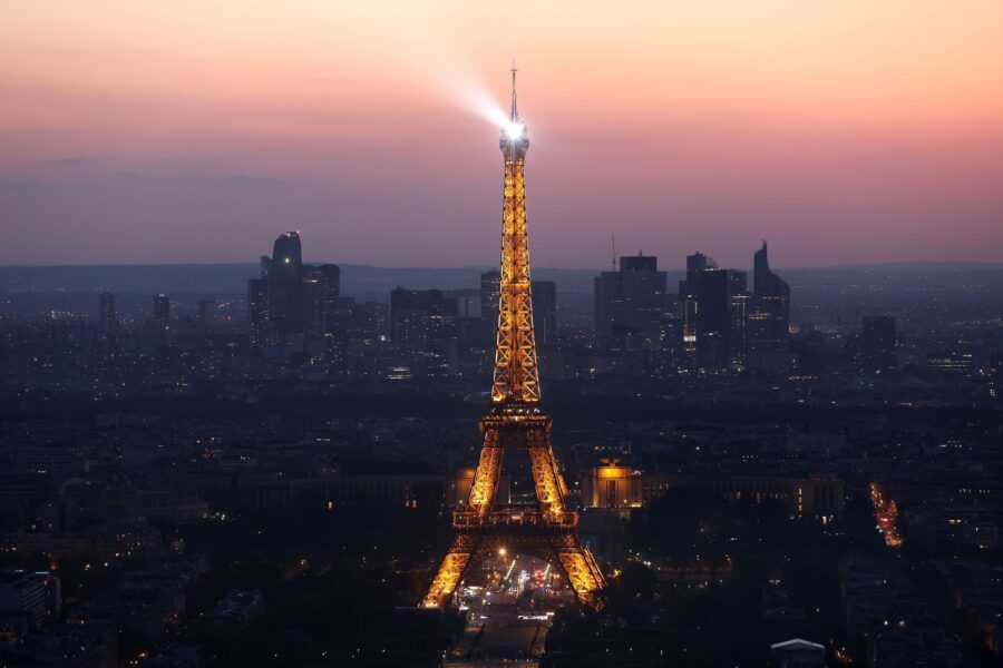 FILE - The Eiffel Tower stands illuminated after sunset on July 07, 2023 in Paris, France. Paris wi...