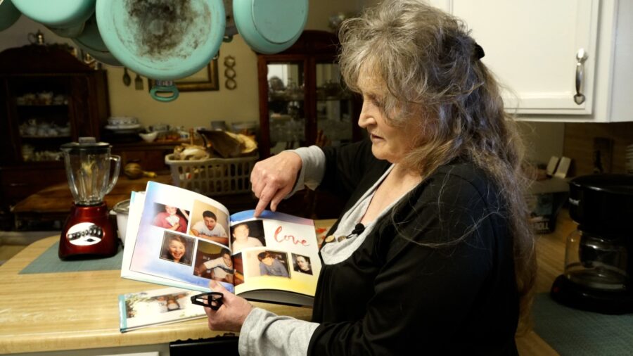 Penny Belgard looks at a photobook with pictures of her son Cody, who was killed by Salt Lake City ...