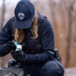 A SLCPD officer, assigned to the Central Patrol Division Bike Squad, conducts a search as part of an investigation into fentanyl possession. (Salt Lake City Police Department)