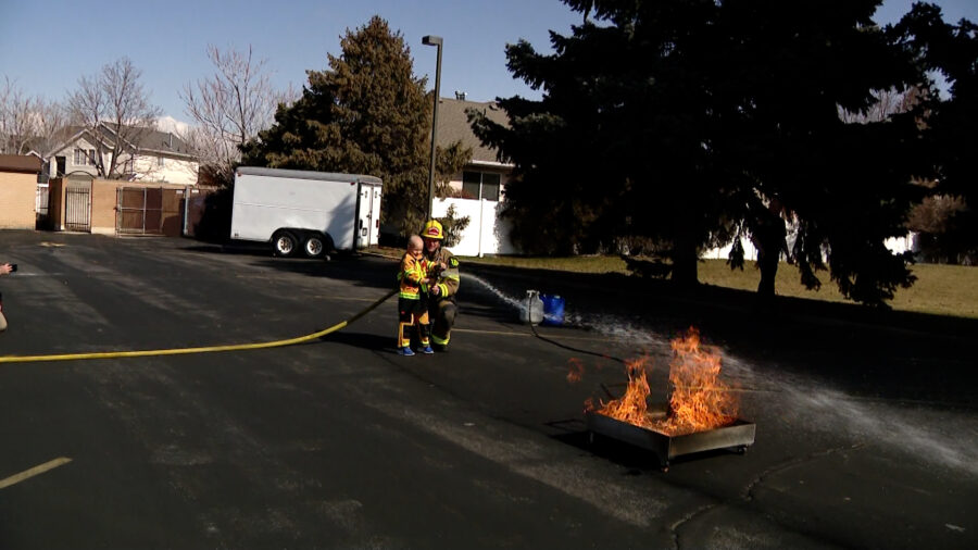 Henry Sorenson fights a small fire with Midvale Fire Department....