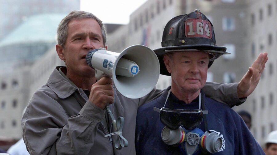 President George W. Bush, left, stands next to retired New York Fire Department firefighter Bob Bec...