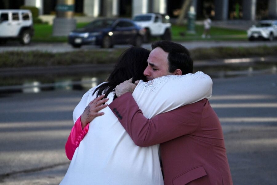 Carlos Gonzalez, a worship singer, hugs a fellow churchgoer after a shooting at Joel Osteen's Lakew...