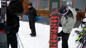 Charlie Duffy shows the snowboard he used