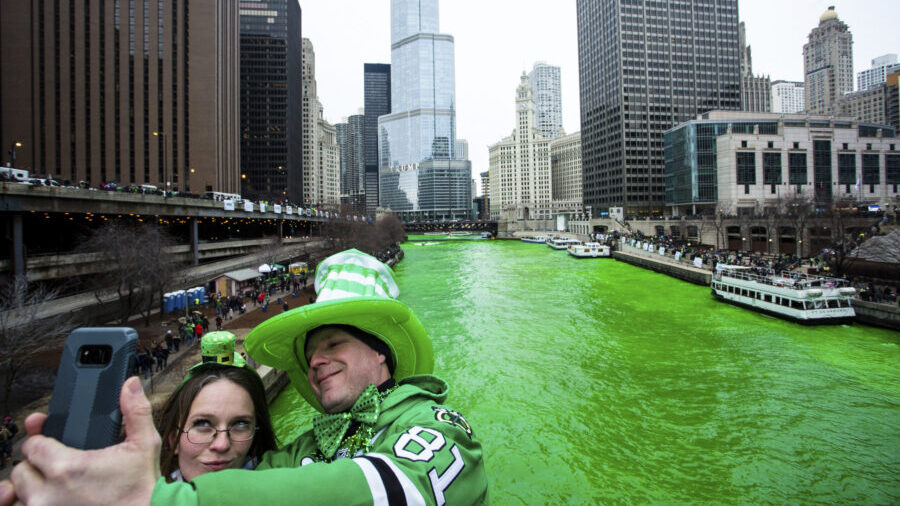 FILE - Stacey Peterson and Kevin McGuire take a selfie in front of the green Chicago River to celeb...