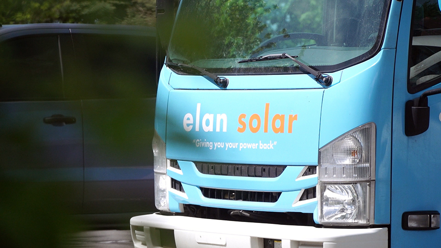 a blue truck with identified with letters "elan solar"...