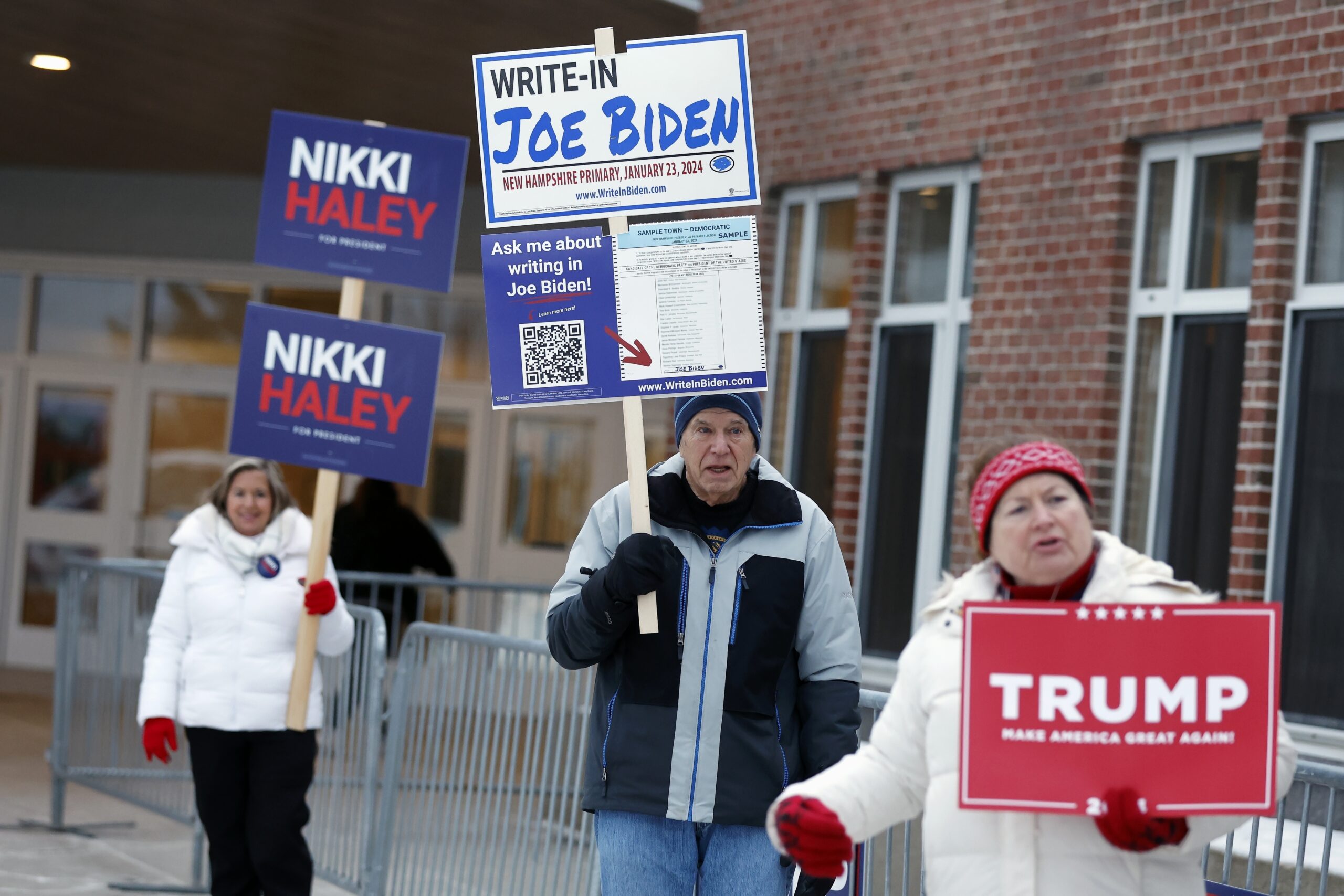 FILE - Candidate supporters stand outside a polling location in the presidential primary election, ...