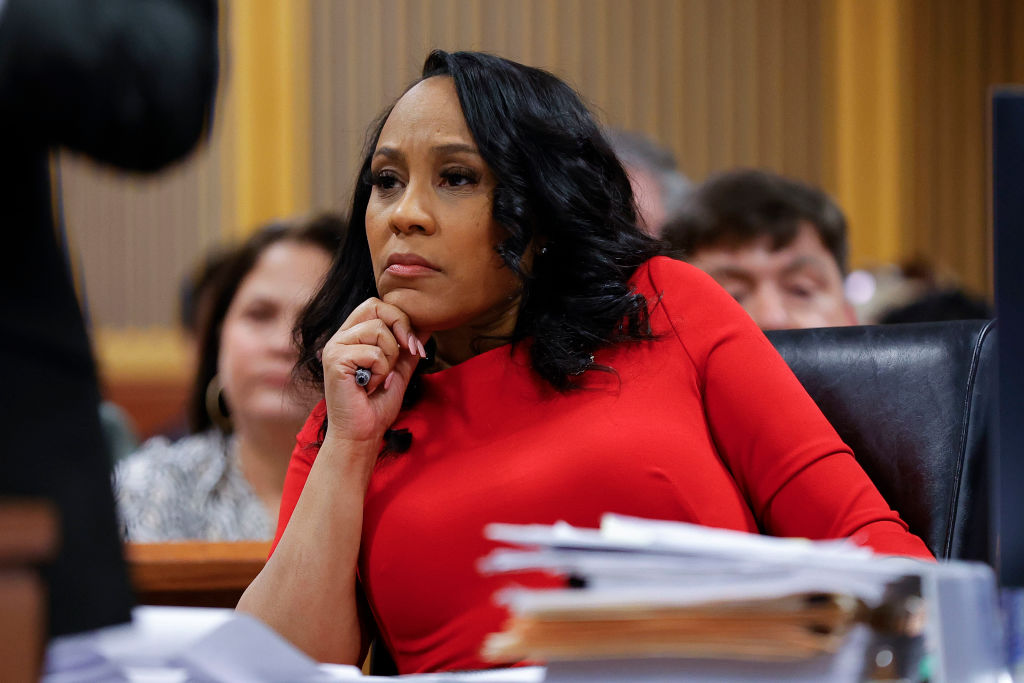 FILE: Fulton County District Attorney Fani Willis looks on during a hearing in the case of the Stat...