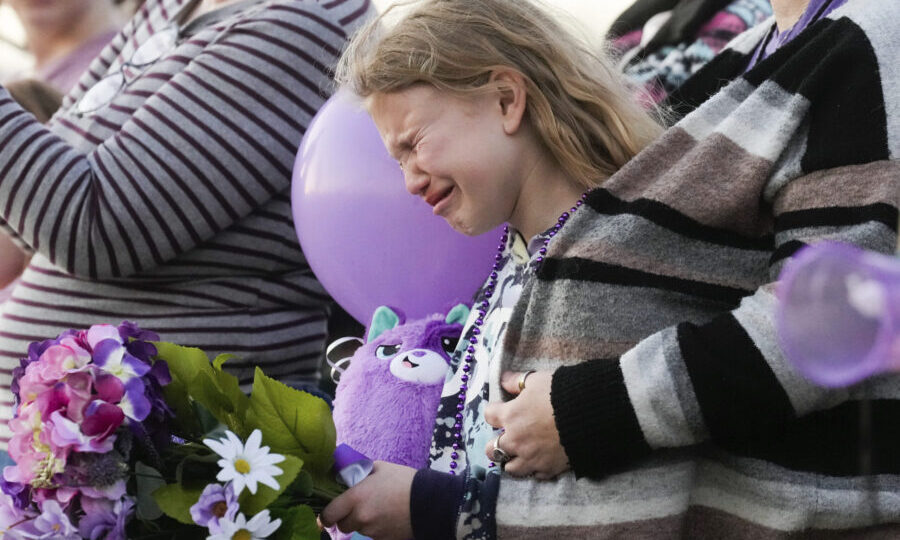FILE - Kristlyn Wood, a cousin of 11-year-old Audrii Cunningham, reacts during a vigil in Cunningha...