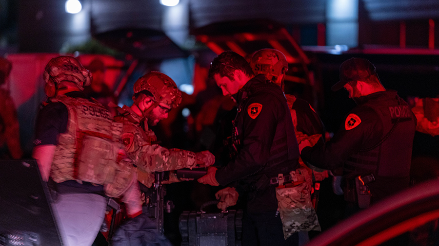 Officers with the Salt Lake City Police Department’s SWAT Team sort out equipment during a call a...