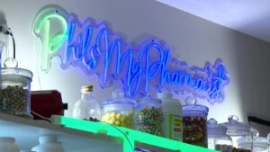 A neon sign promoting the PhilsMyPharmicist account.