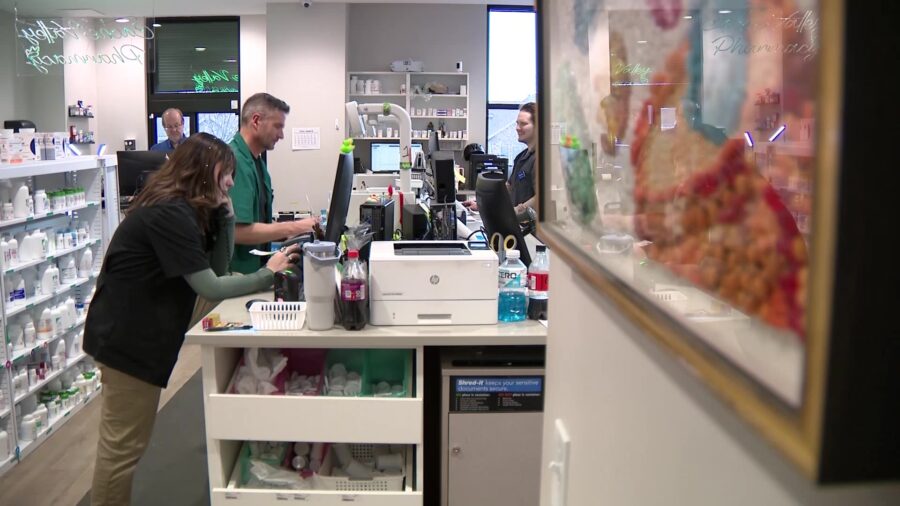 Cache Valley Pharmacy owner, Phillip Cowley working with employees....