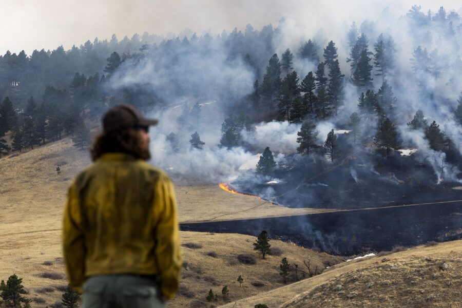 A firefighter watches as a fire burns through grass on March 26, 2022 in Boulder, Colorado.
Mandato...