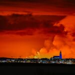 The skyline of Reykjavik is against the backdrop of orange coloured sky due to molten lava flowing out from a fissure on the Reykjanes peninsula north of the evacuated town of Grindavik, western Iceland on March 16. (	Halldor Kolbeins, AFP/Getty Images)