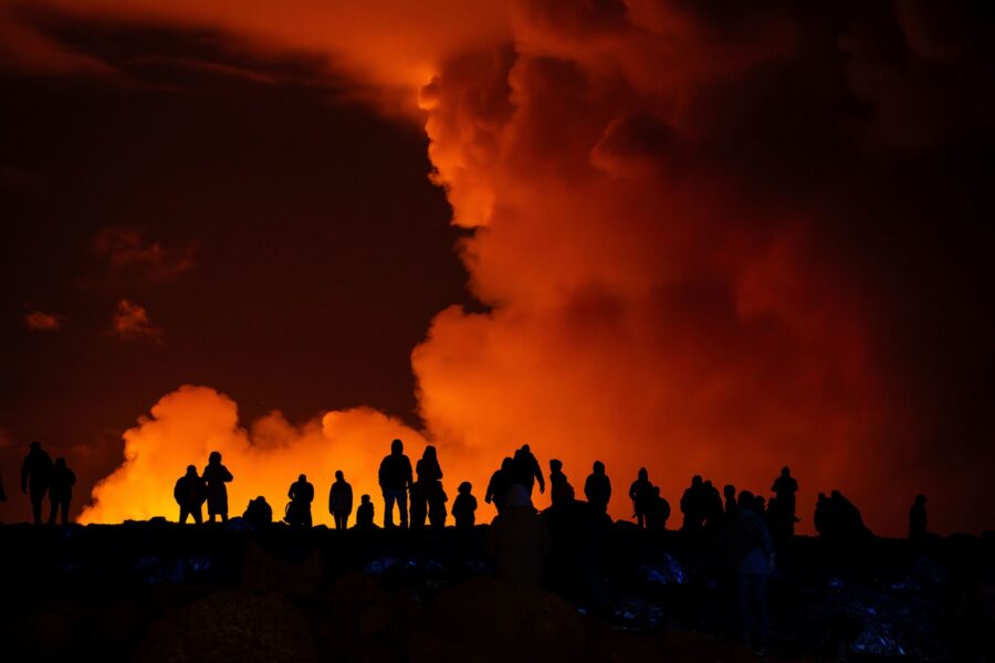 Spectators watch plumes of smoke from volcanic activity between Hagafell and Stóra-Skógfell in Ic...