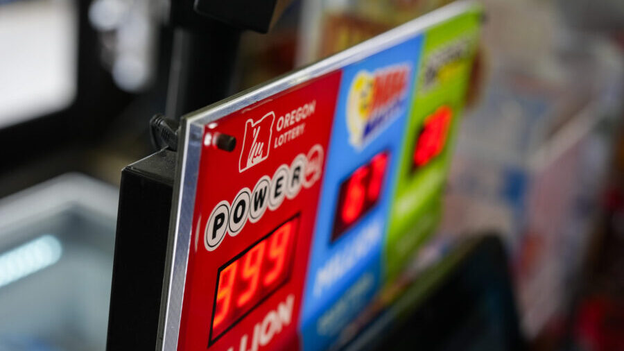 A sign for the Powerball jackpot is displayed at a 7-Eleven, Friday, April 5, 2024, in Portland, Or...