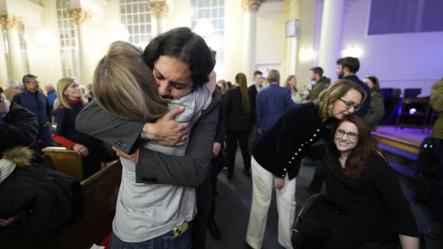Tim Hernandez hugs Kallie Leyba as former Arizona Rep. Gabby Giffords, second from right, hugs Anne...