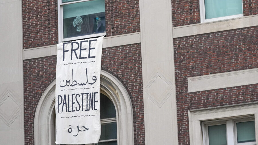 Demonstrators are seen through a window inside Hamilton Hall inside the Columbia University campus,...