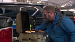 Robertson cooking some burgers in the parking lot of the resort. 